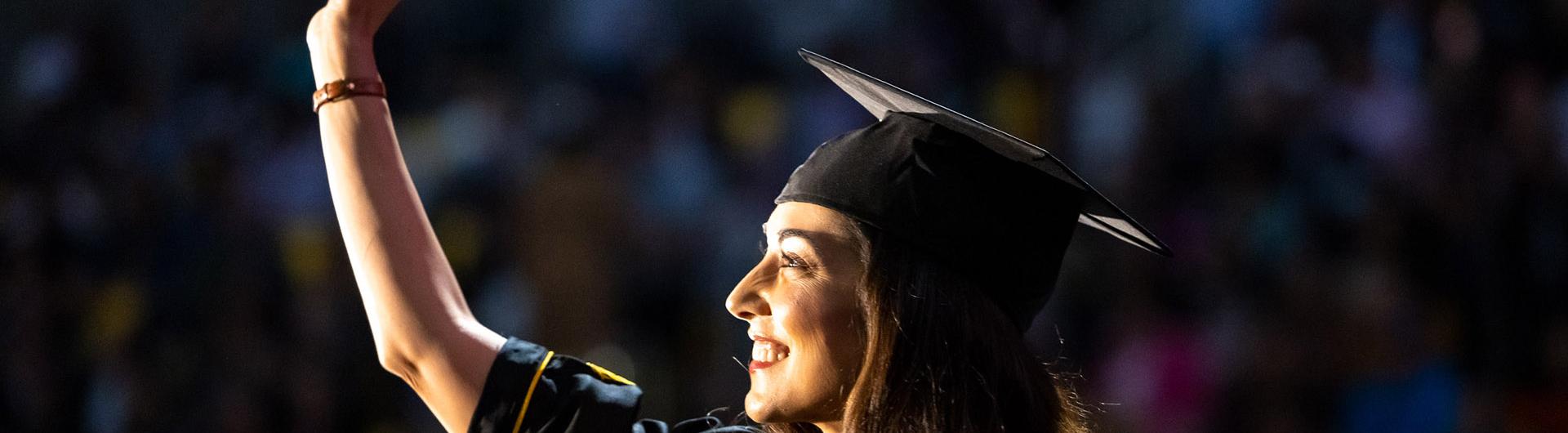 Recent graduate waving