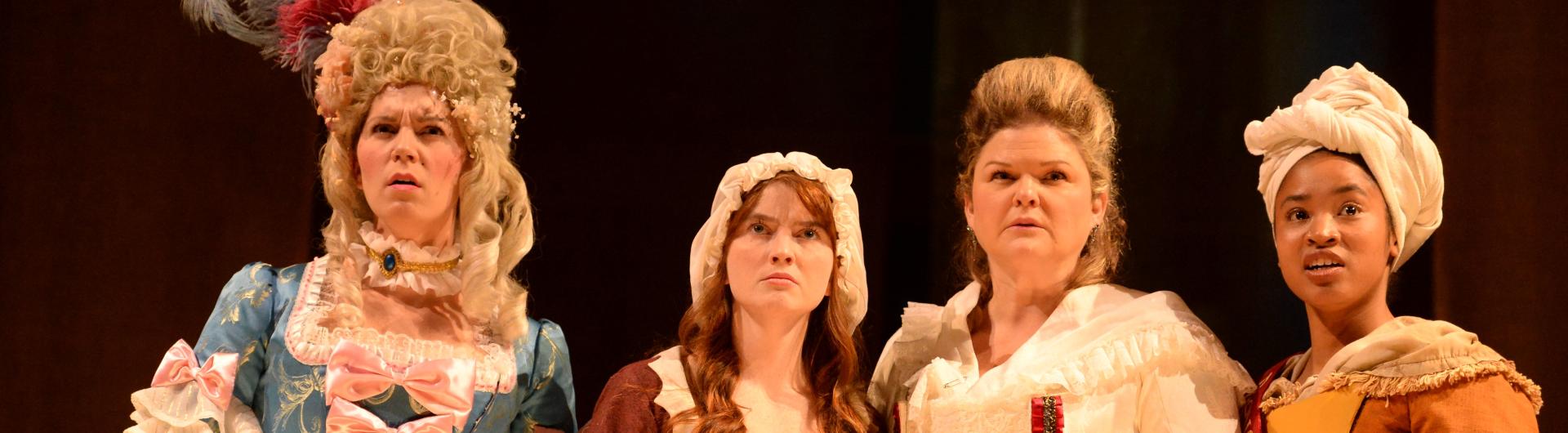 Four actresses on stage wearing revolutionary-era costumes