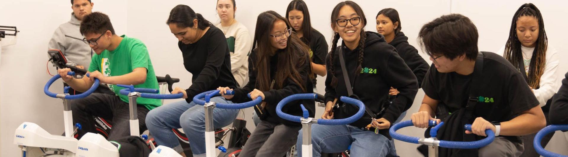 Students on stationary bikes