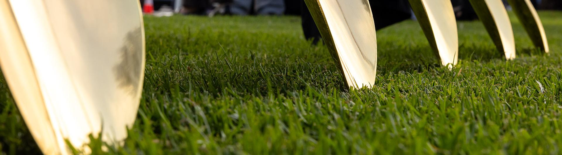 Banner of shovels on grass used for La Playa groundbreaking