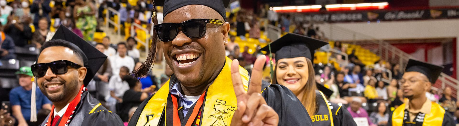 A graduate wearing regalia during a ceremony.