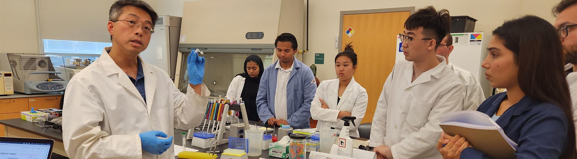 Dr. Kent Lee explaining lab procedures to students