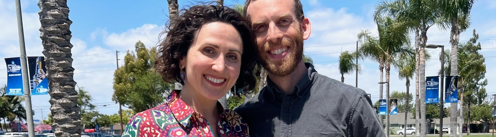 Associate Professor Andrea Caban stands with Department Chair Ezra Lebank with her 2024 Distinguished Faculty Scholarly and Creative Achievement Award