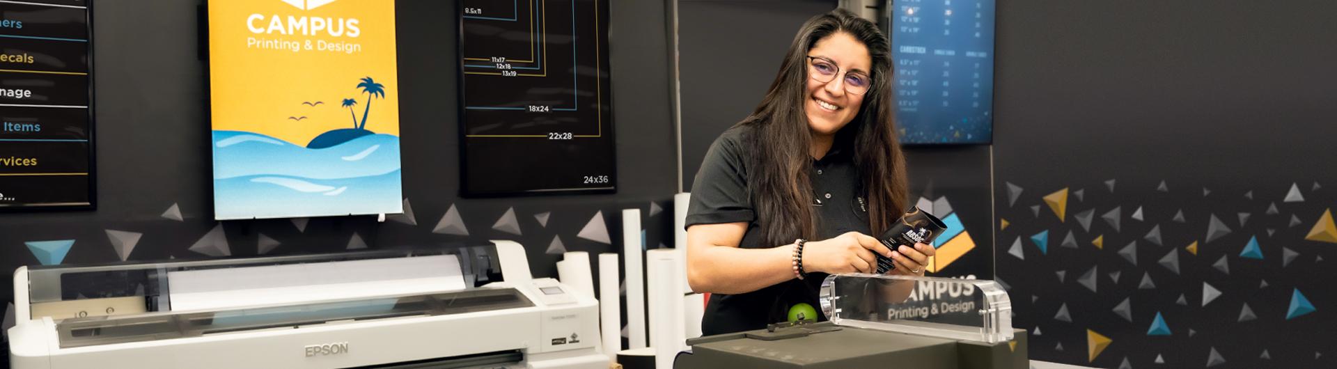 Beach Shops employee smiling for the camera inside of the Campus Print and Design.