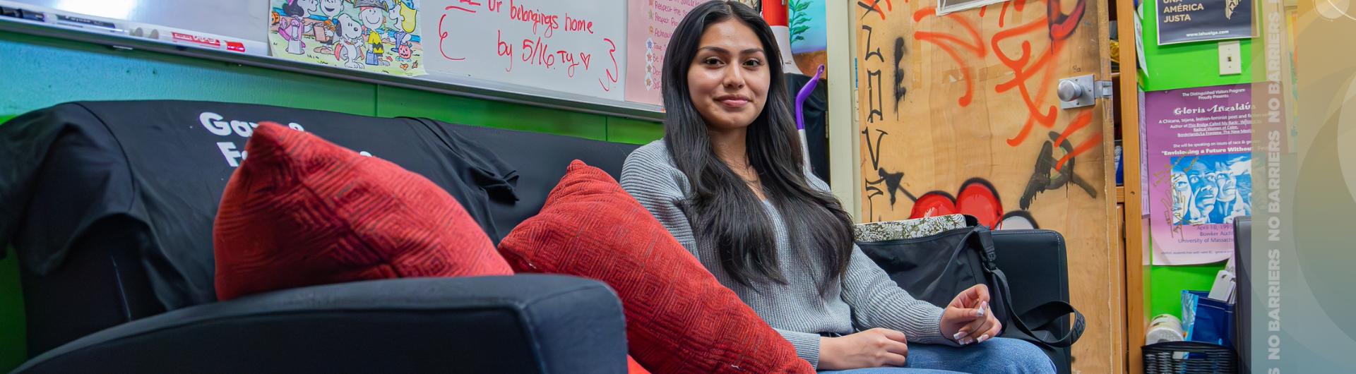 Ivonne Hernandez sits on a couch at the Latinx Resource Center