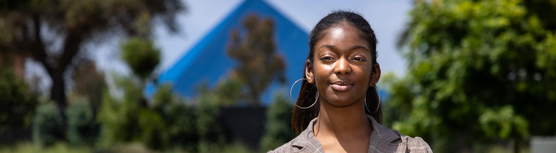 Student Chloe Thomas, an inaugural recipient of the Black Student Success Scholarship, with Walter Pyramid in background