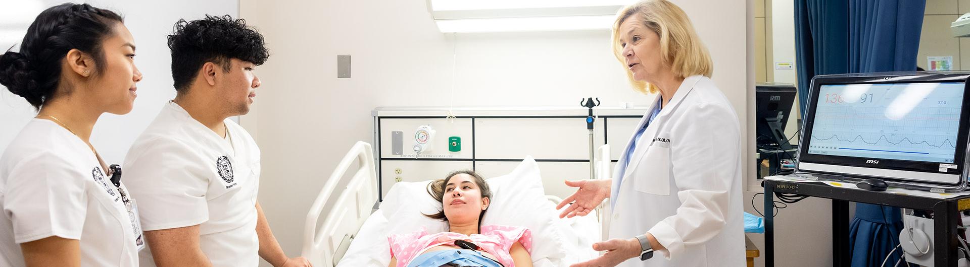 School of Nursing students conduct a mock examination of a patient