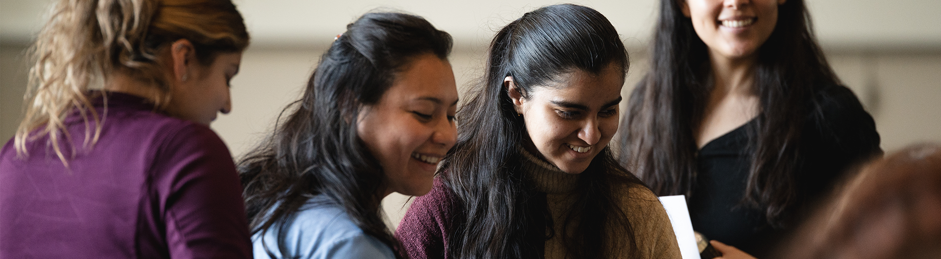 Group of diverse students engaging in a conversation at an event