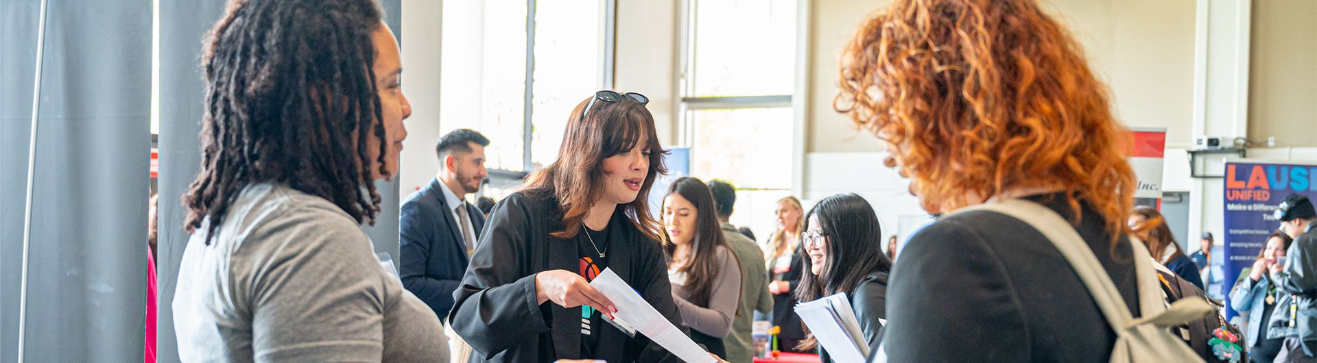 Students discussing job opportunities with recruiters at a career fair