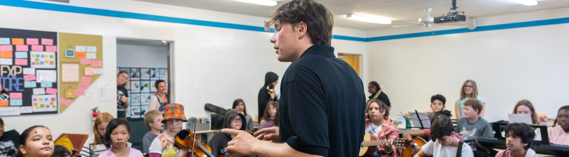 Beach student Ben Rifkin teaching music to children