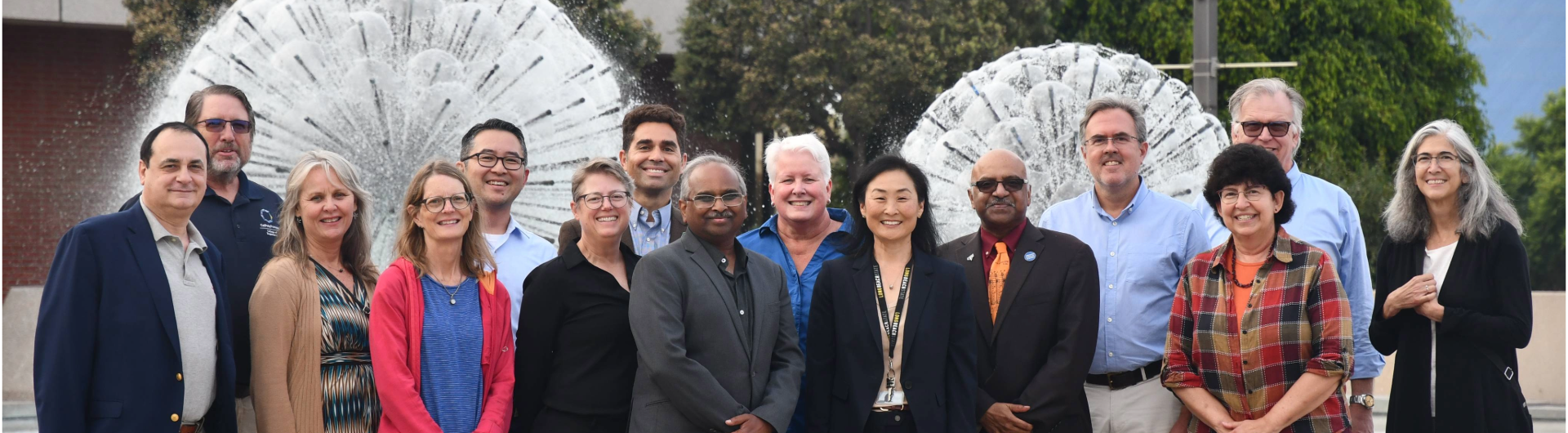 College of Engineering Deans posing for a photo in front of the Brotman Hall Foutain and the Walter Pyramid in the background