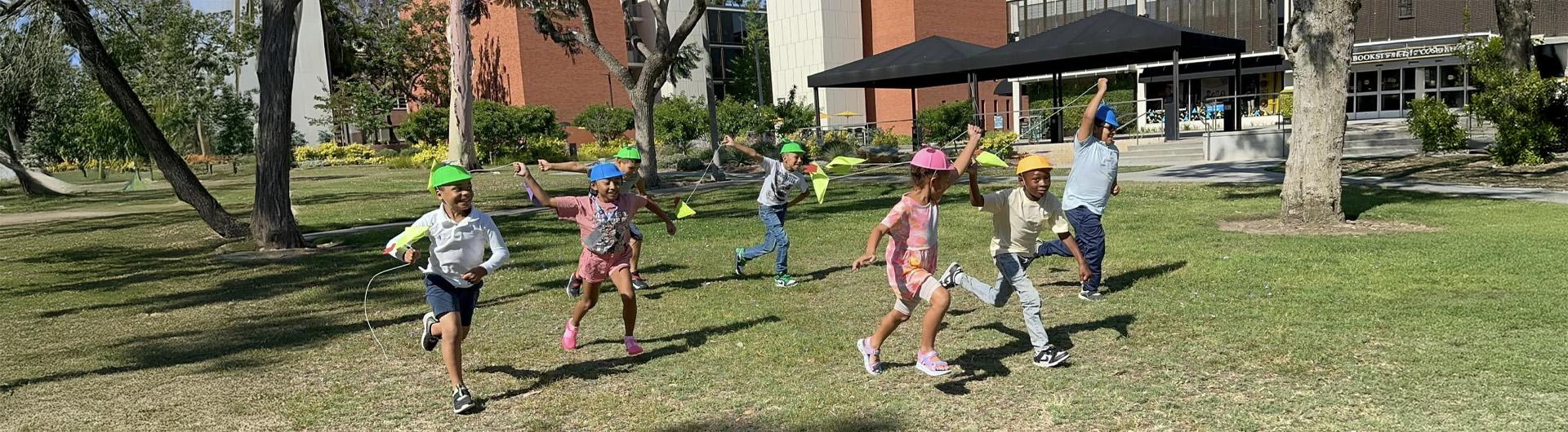young children running with kites
