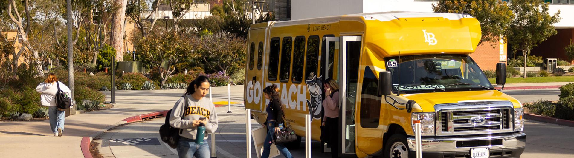 Students exiting a campus shuttle