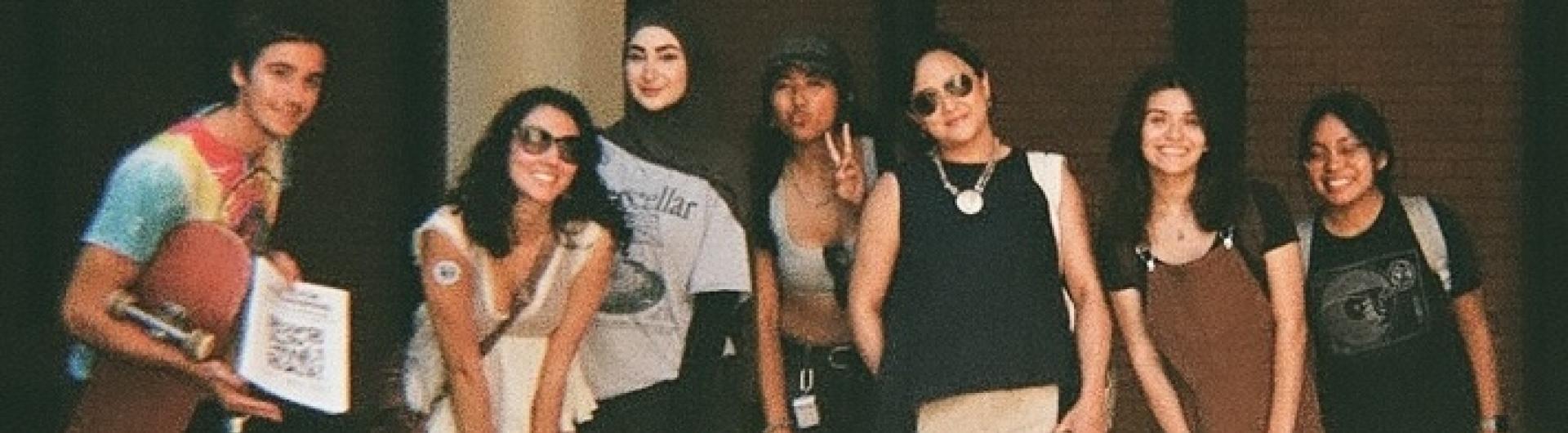 group of people posing in dark area