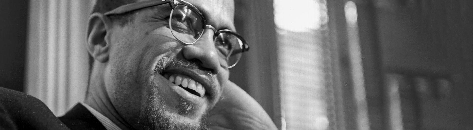 Photo of a smiling Malcolm X