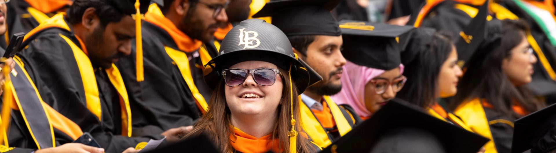 Student wearing LB helmet during Commencement