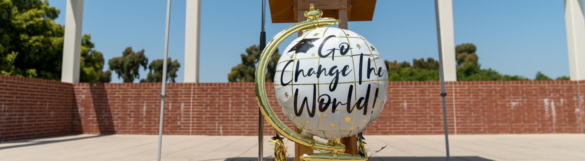 Balloon with text "Go change the world!"
