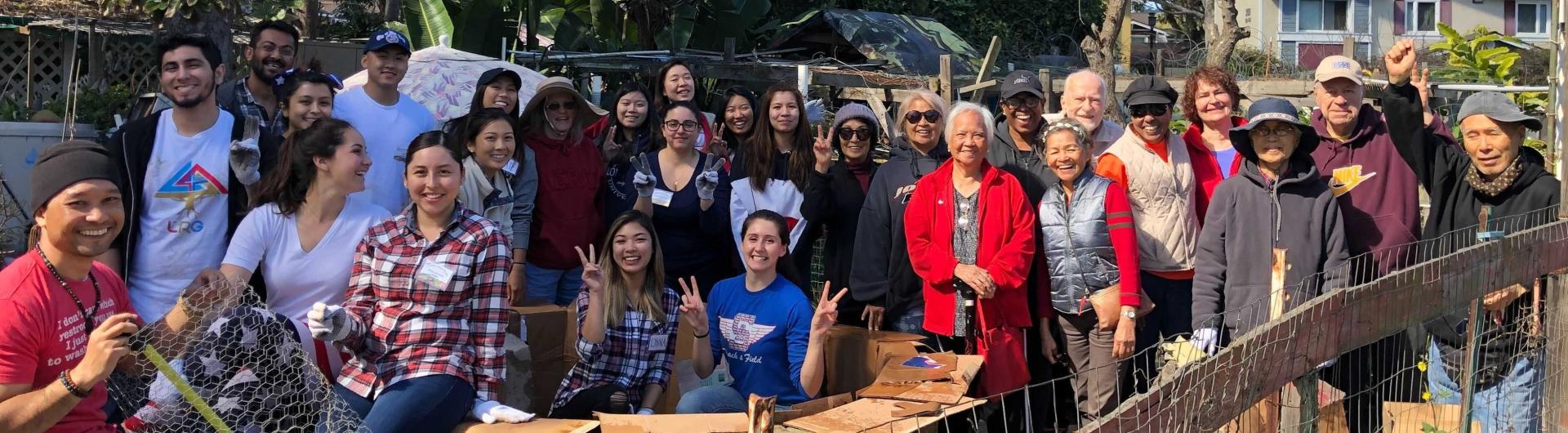 Community volunteers gathered outdoors for a garden cleanup.