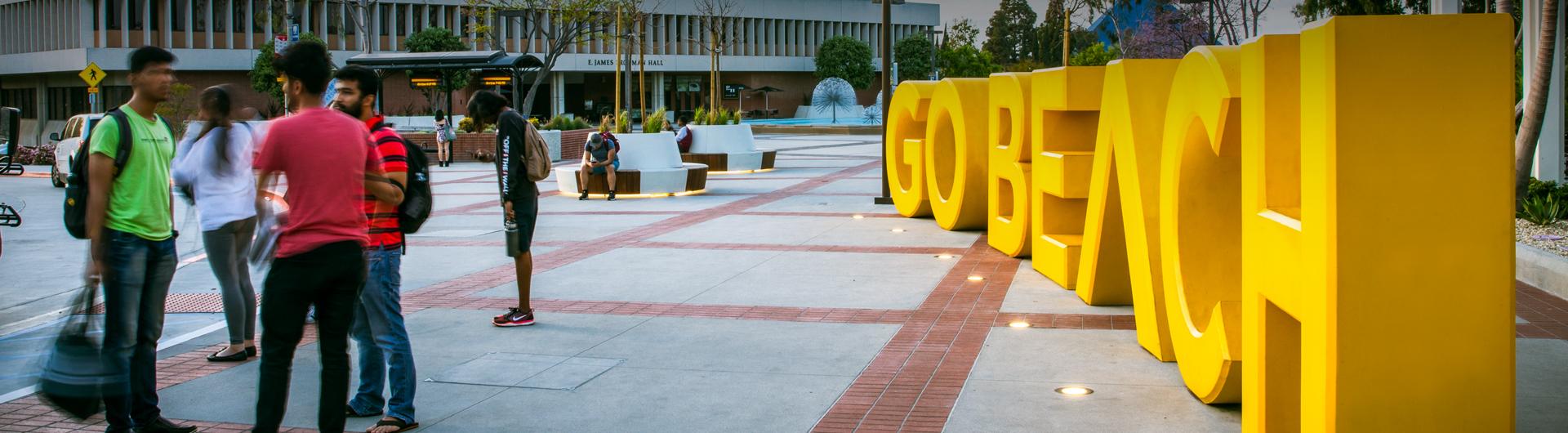 Students in front of Go Beach Landmark