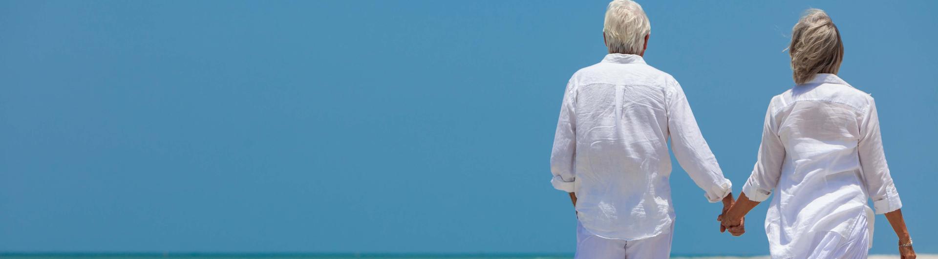 Old folks walking on the beach