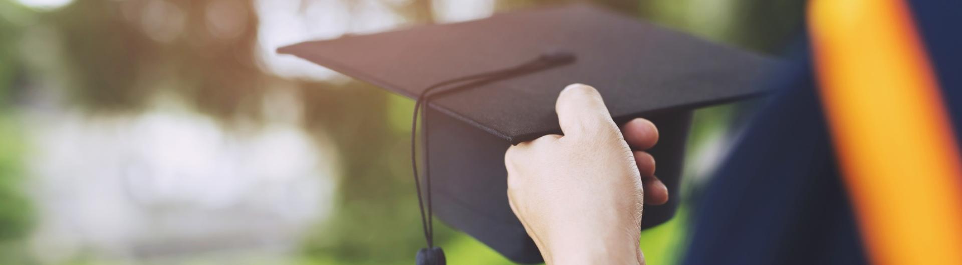 Student hold hats in hand during commencement success graduates 