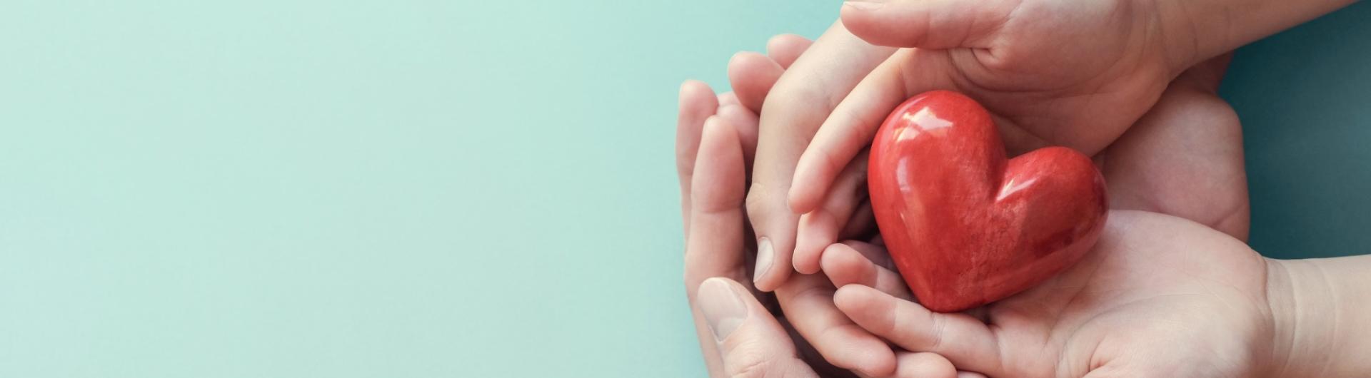 Hands holding a heart banner