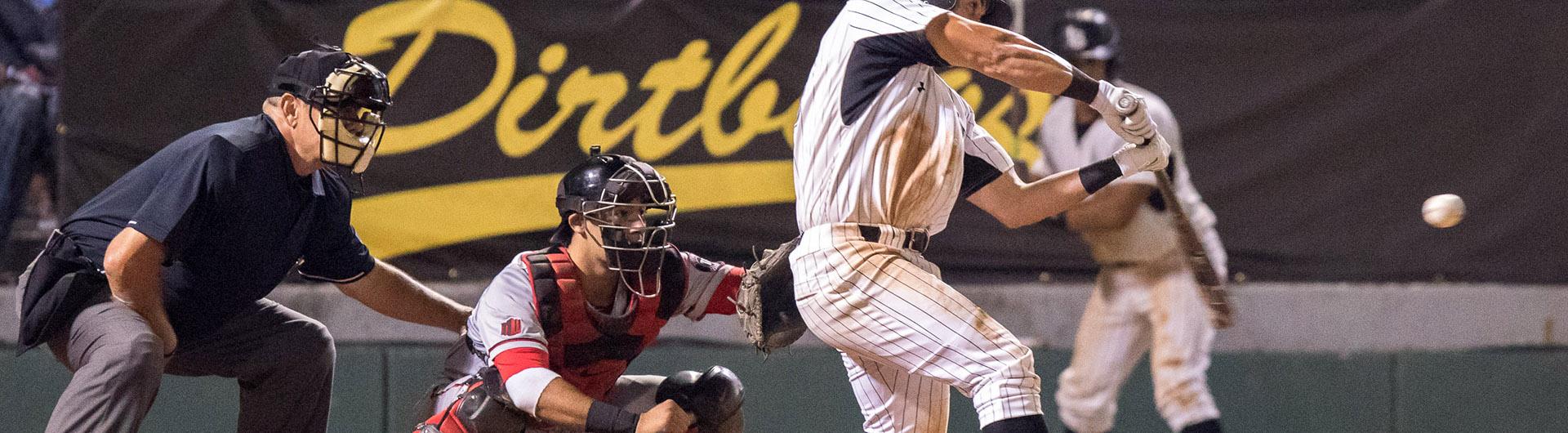 Baseball player hitting a baseball.