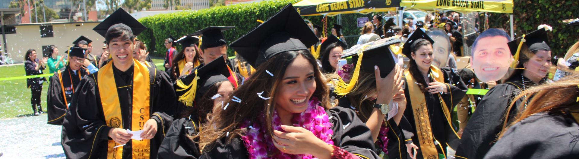 graduating students walking through confetti