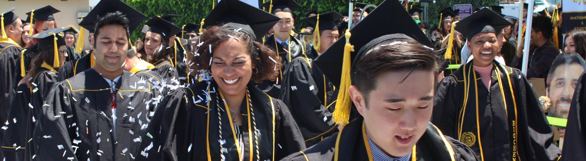 graduating students walking through confetti