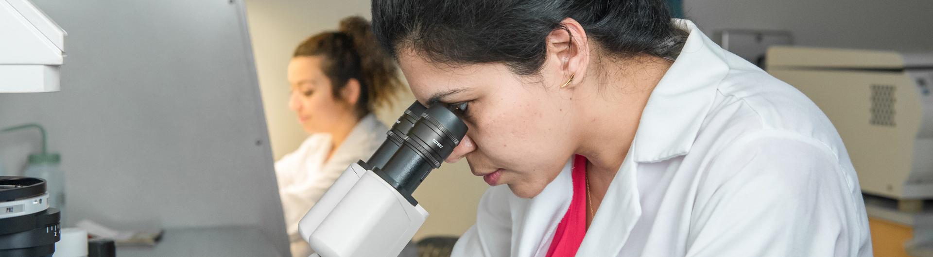 Dr. Bhandari working in the lab with a student