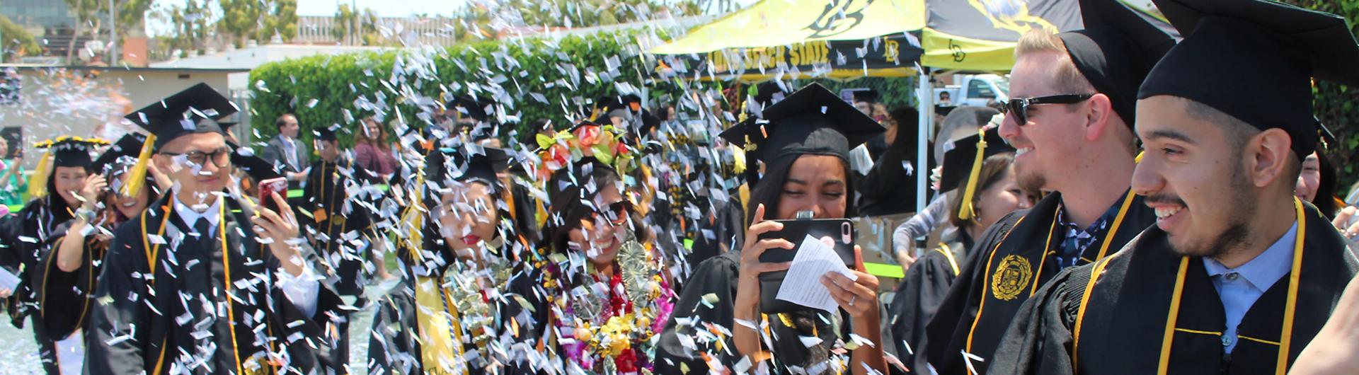 graduating students walking through confetti