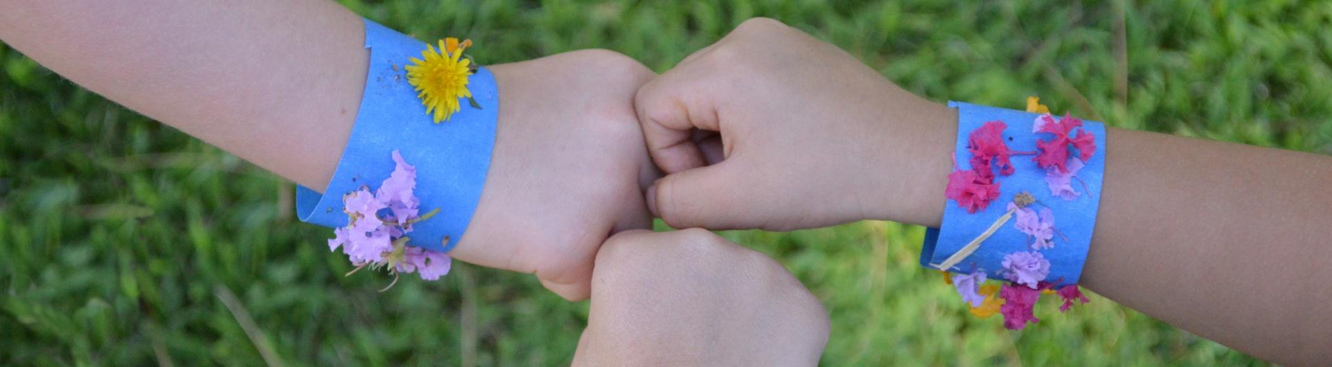 children showing off bracelets made from flowers