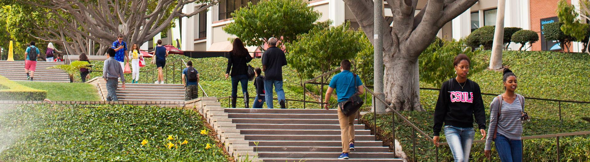 Students walk up and down the steps leading to Friendship Walk