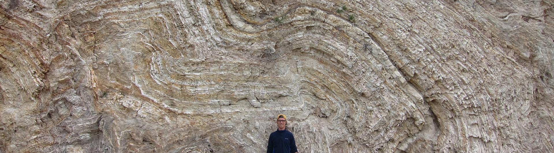 geology student posing in from of a rock formation