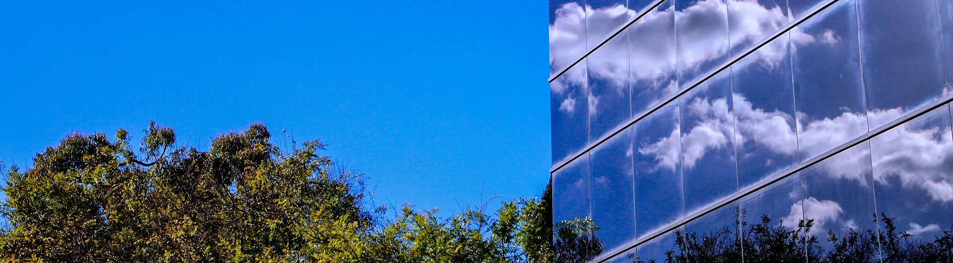 CBA Corner building with clouds.  