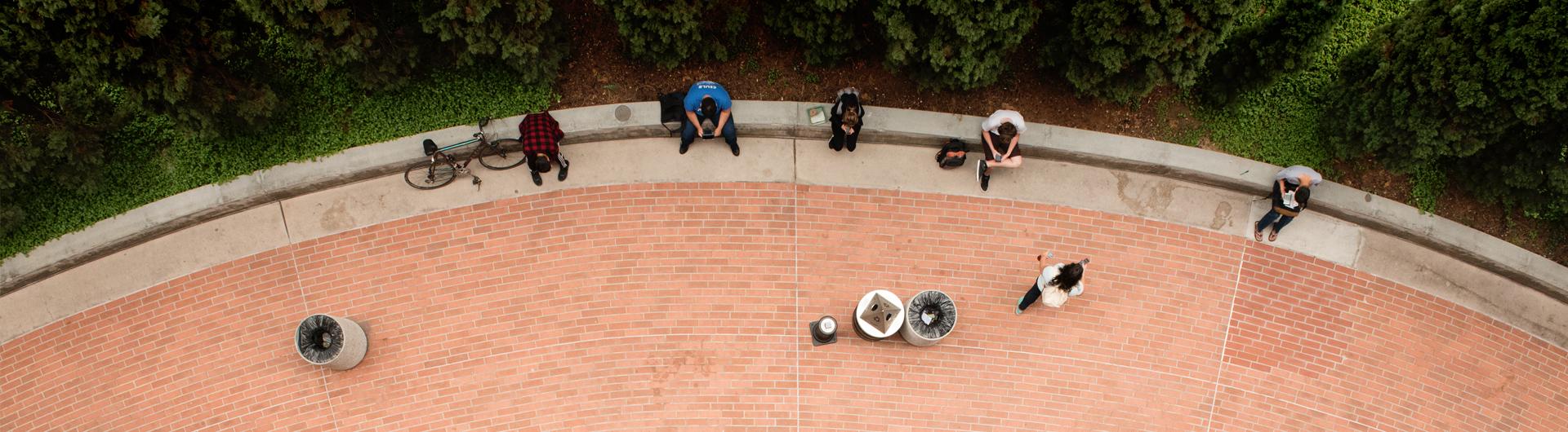 Students studying on the side of CBA building