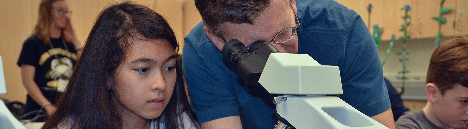 Professor and visiting students in lab