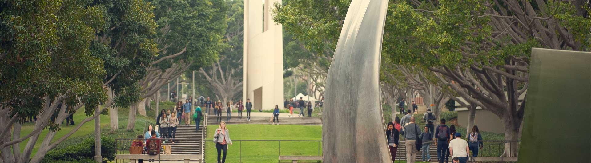 Page banner: A view of the campus "Now" sculpture. CSULB students walking up and down the stairs
