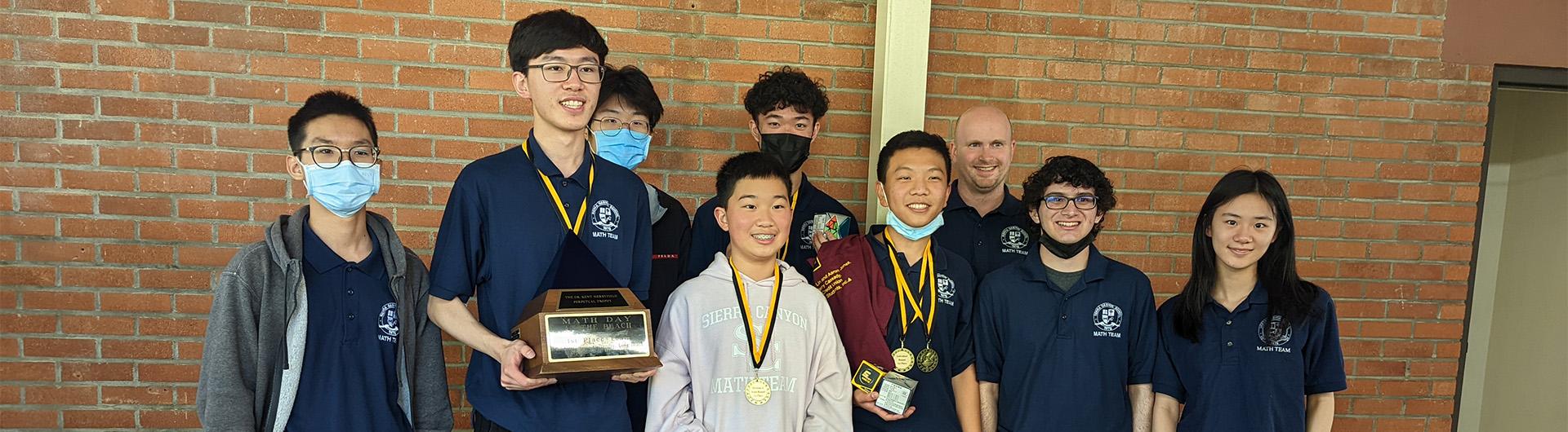 Math Day winners holding trophies and medals