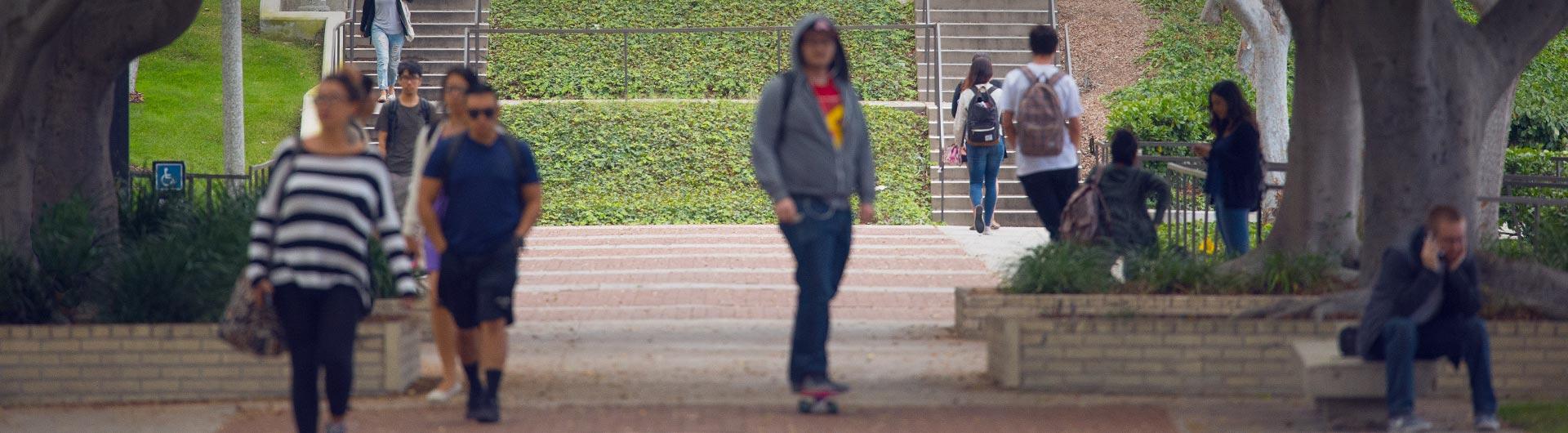 Students walking and riding on Friendship Walk