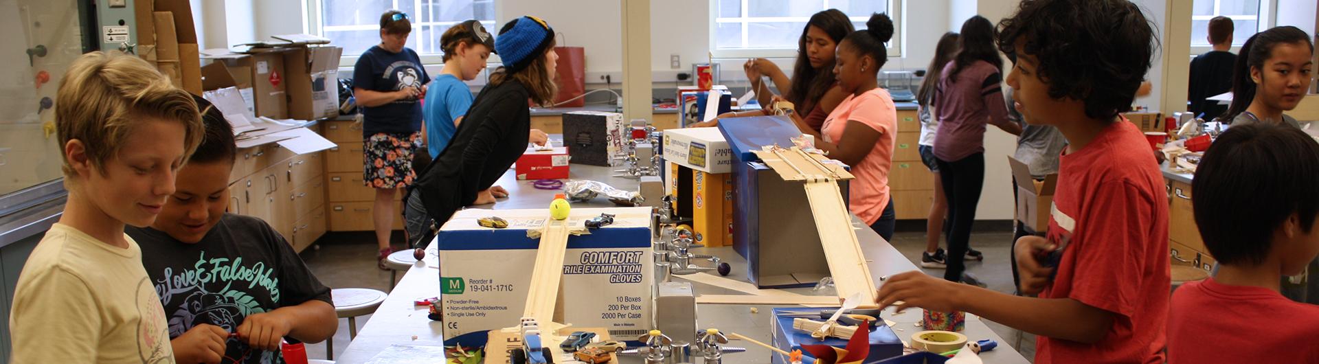 assignment paper science children building ramp structures with cardboard boxes