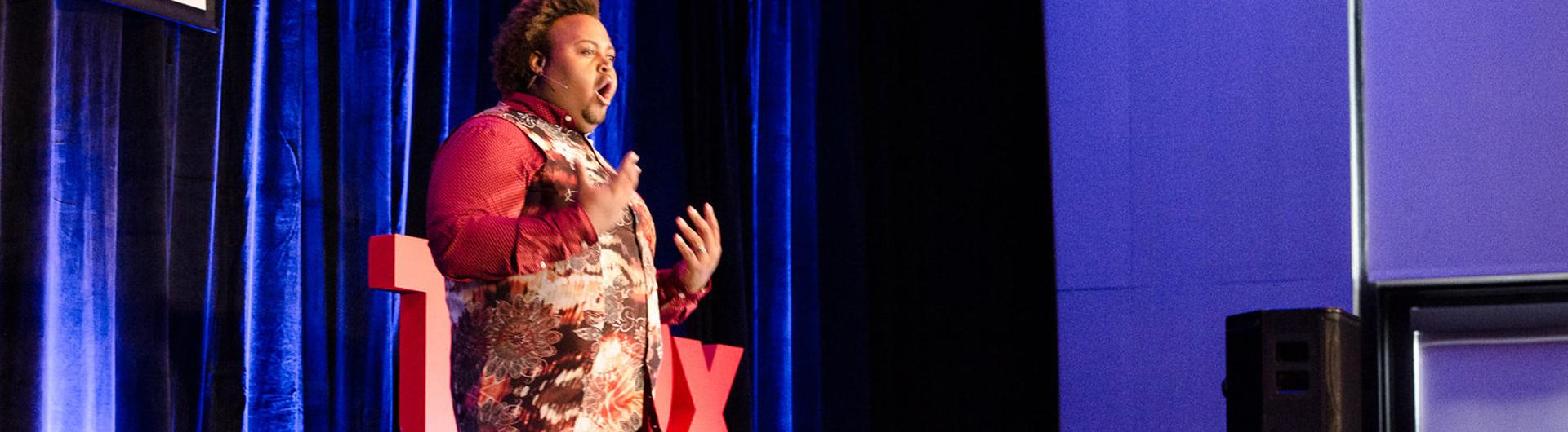 A speaker presents at a TEDxCSULB Event