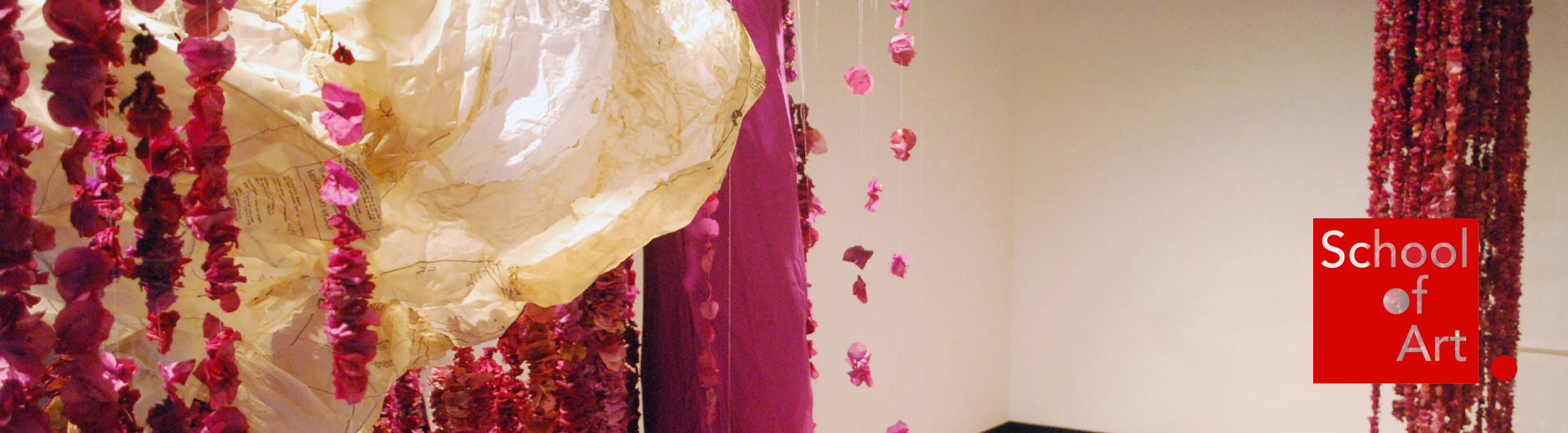 Brightly colored textiles displayed in a gallery