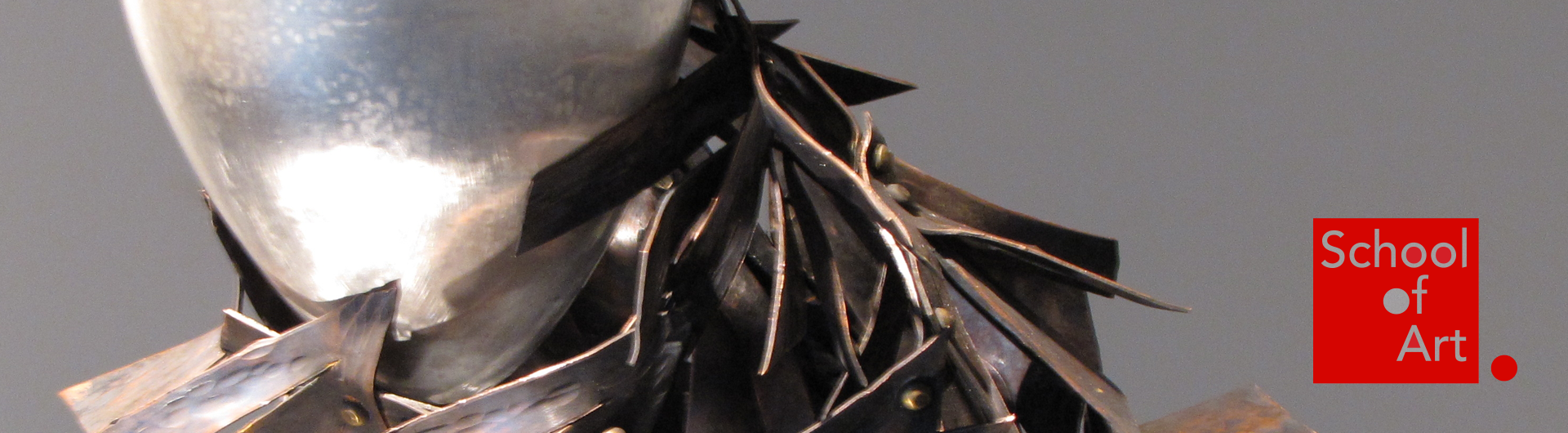 Extreme closeup of metal sculpture on display in a gallery
