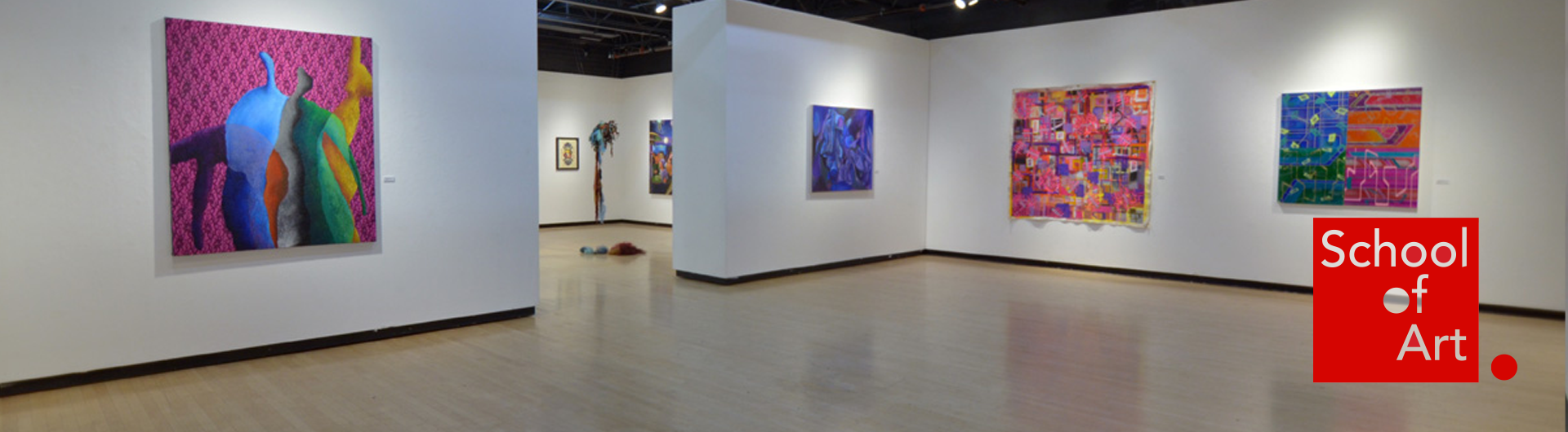 Brightly colored paintings in an art gallery