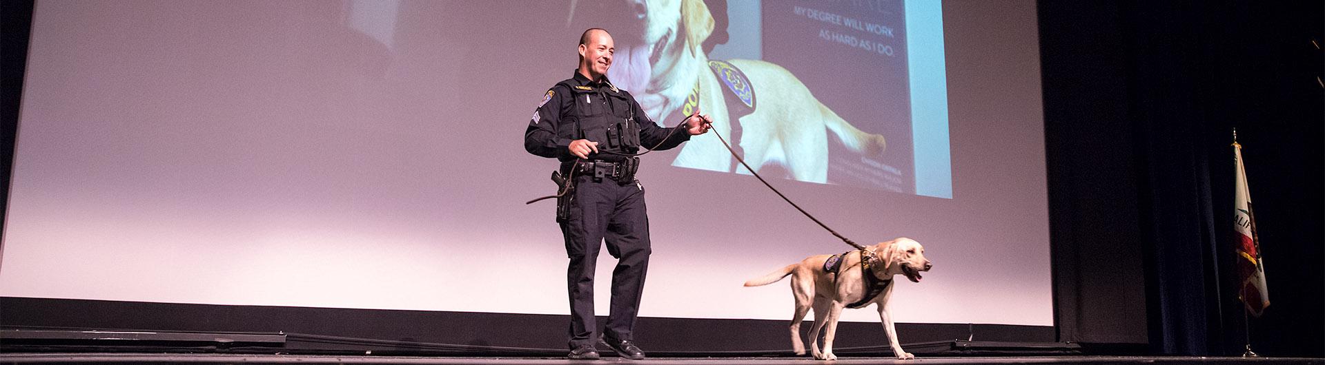 Sargent Ray Gonzalez with Avery onstage at Convocation