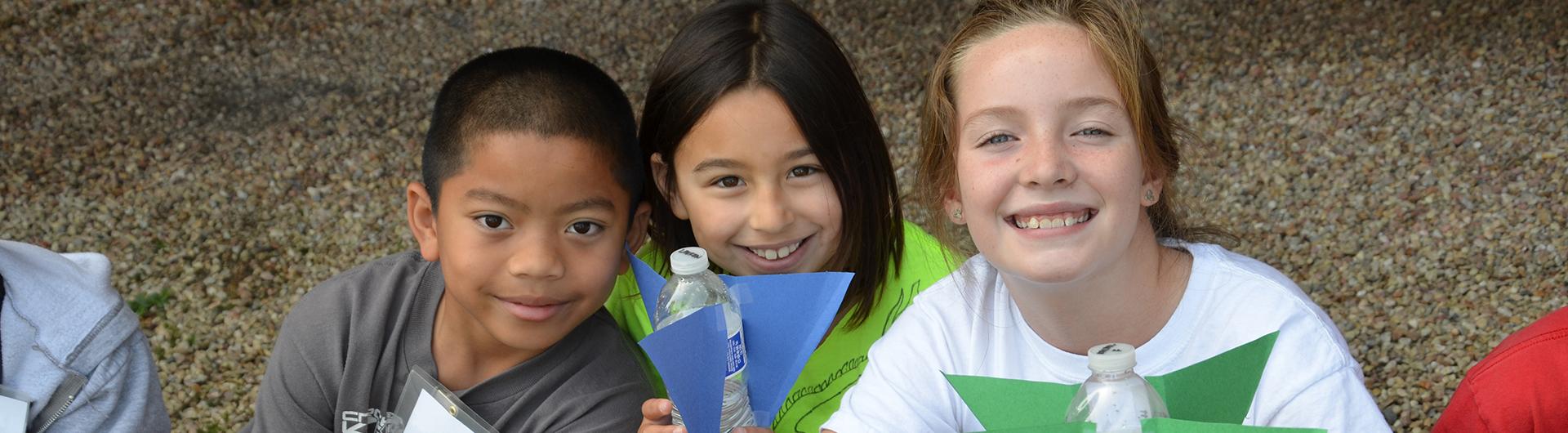 children showing off their rockets made from water bottles