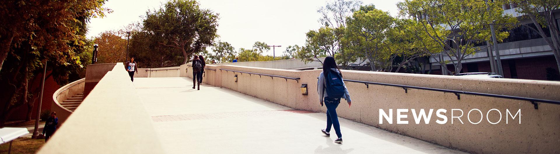 Students walking over a bridge near Brotman Hall