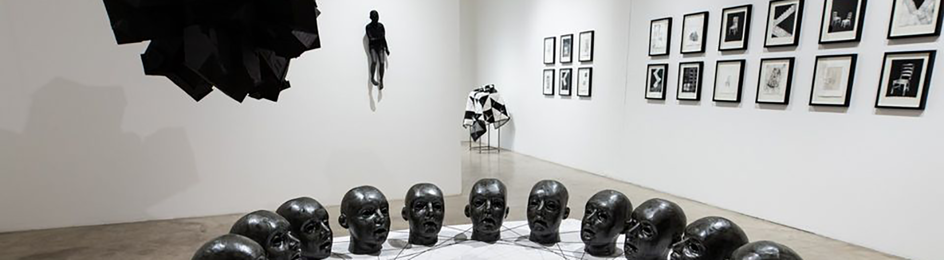 Art gallery interior showing sculptures and prints