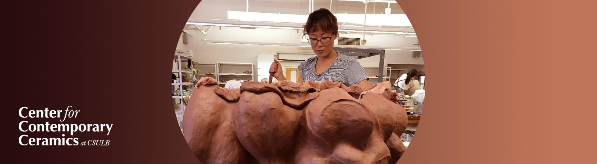 Ceramics student makes artwork with clay.